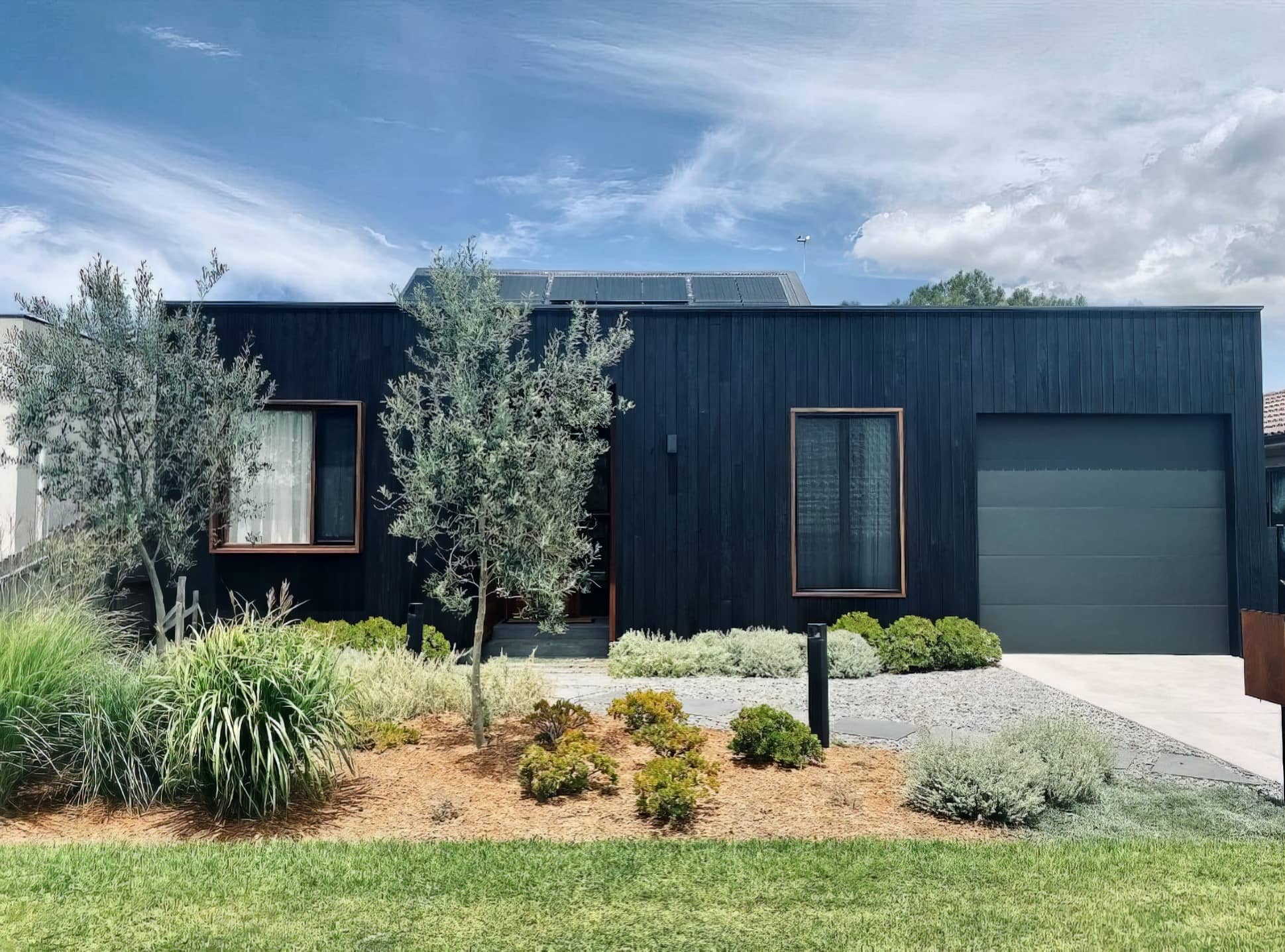 Contemporary home with professionally painted dark cladding