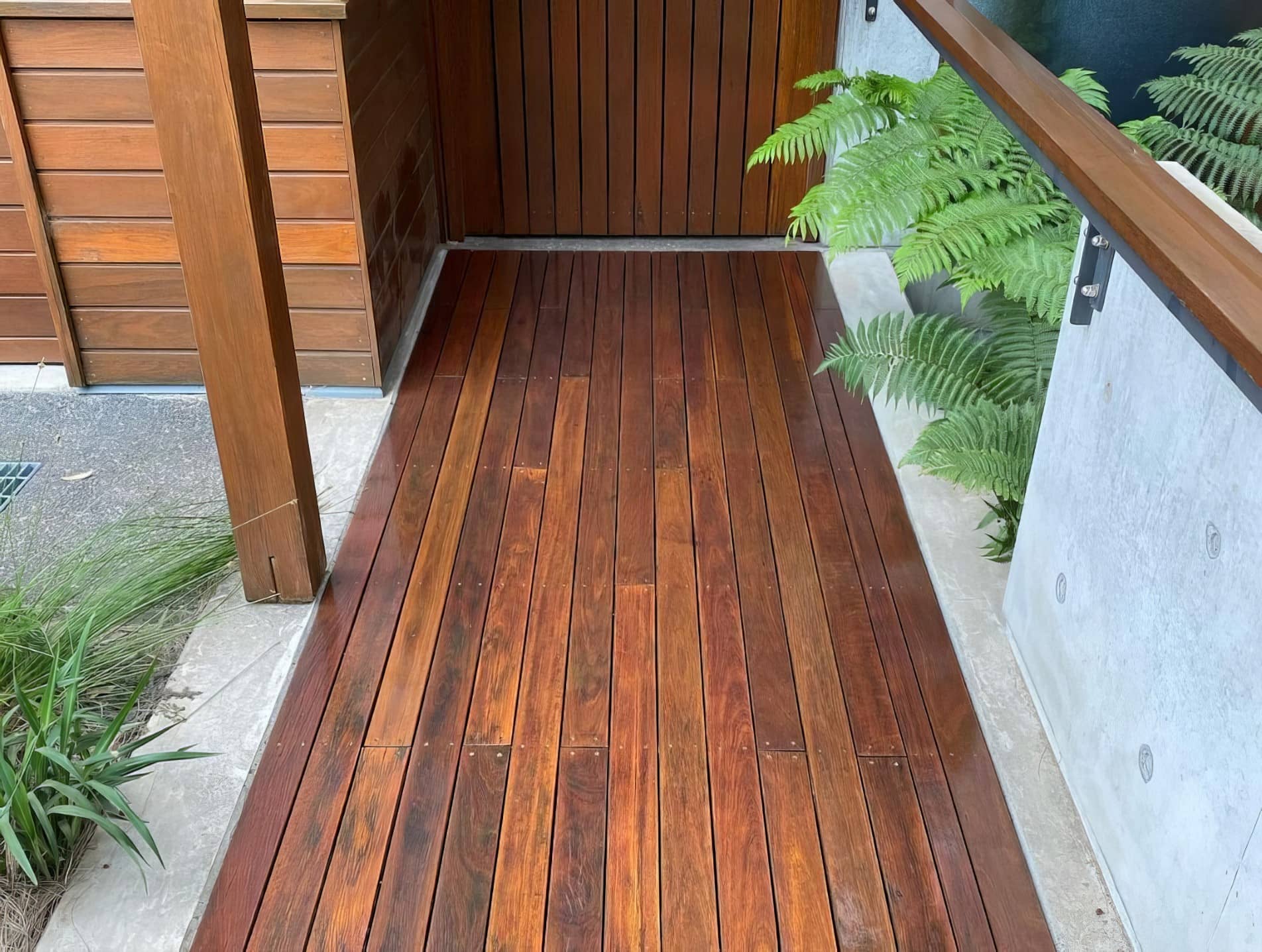 Timber deck being stained and sealed by a professional painter