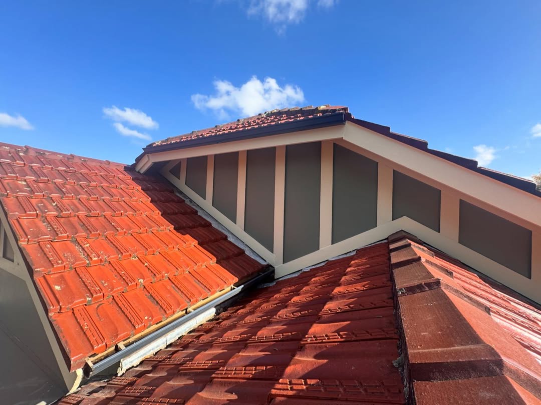 Close-up of freshly painted dormer window trim on a house exterior