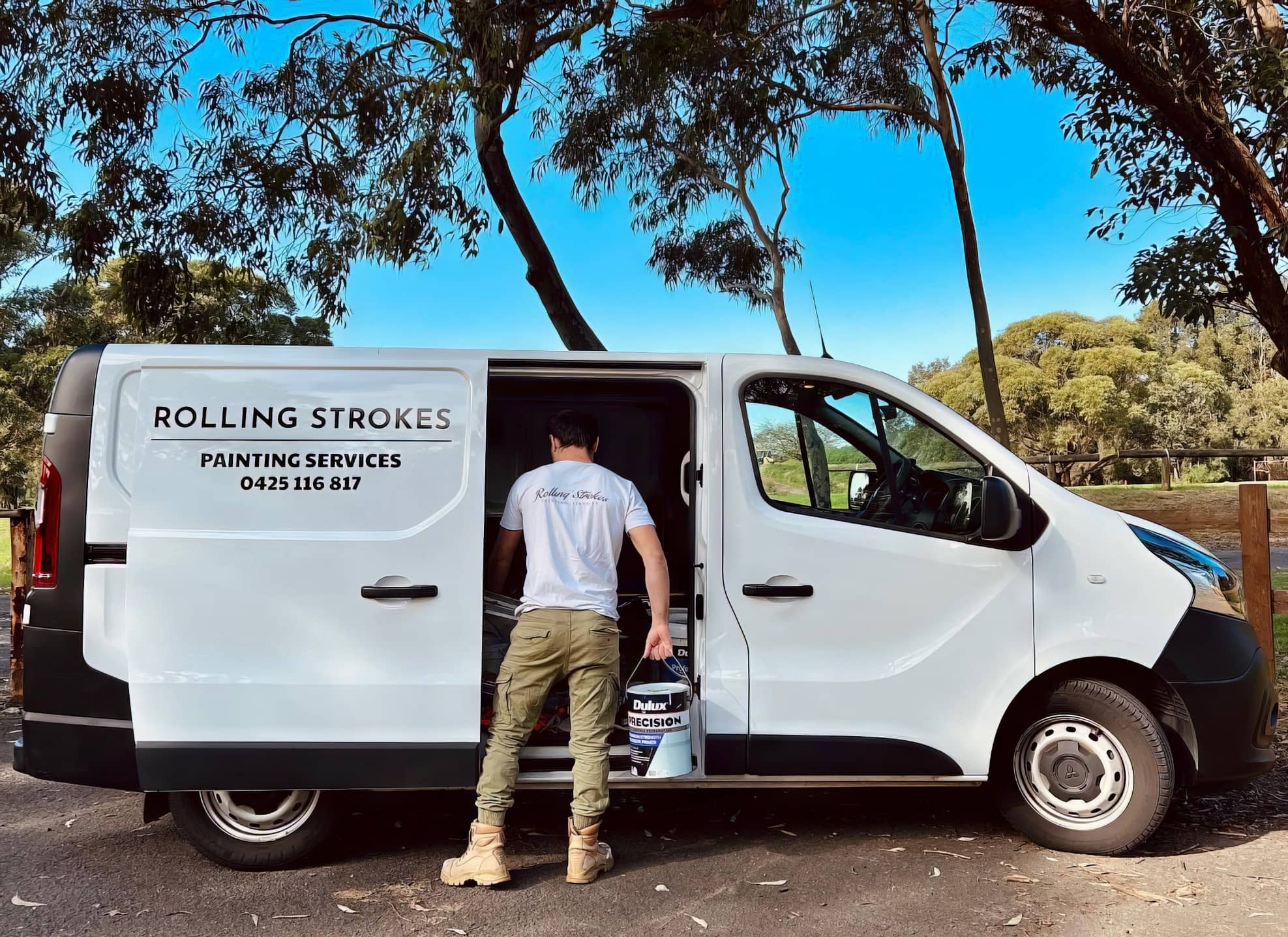 Rolling Strokes painting team beside their branded work van